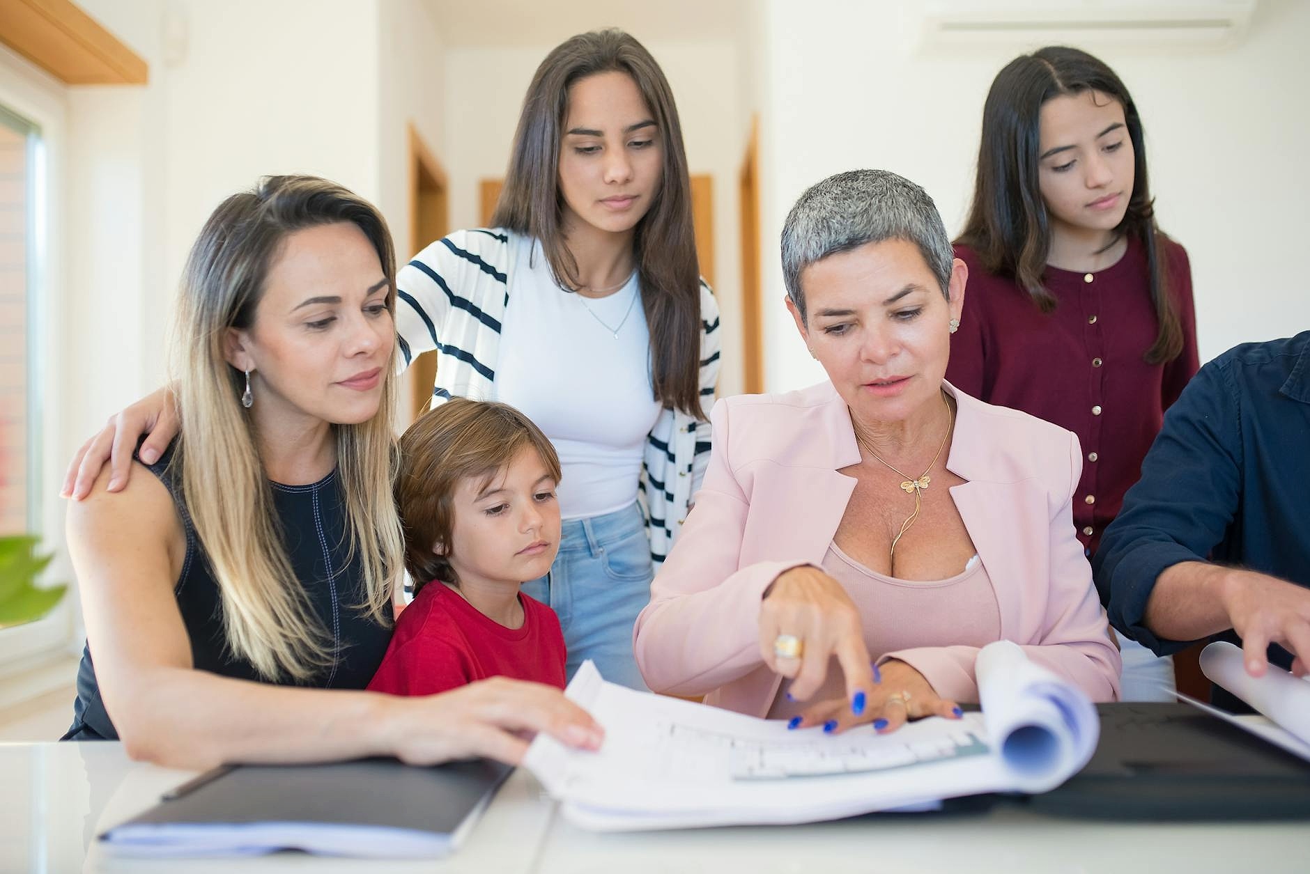 Family reviewing education cost documents at home